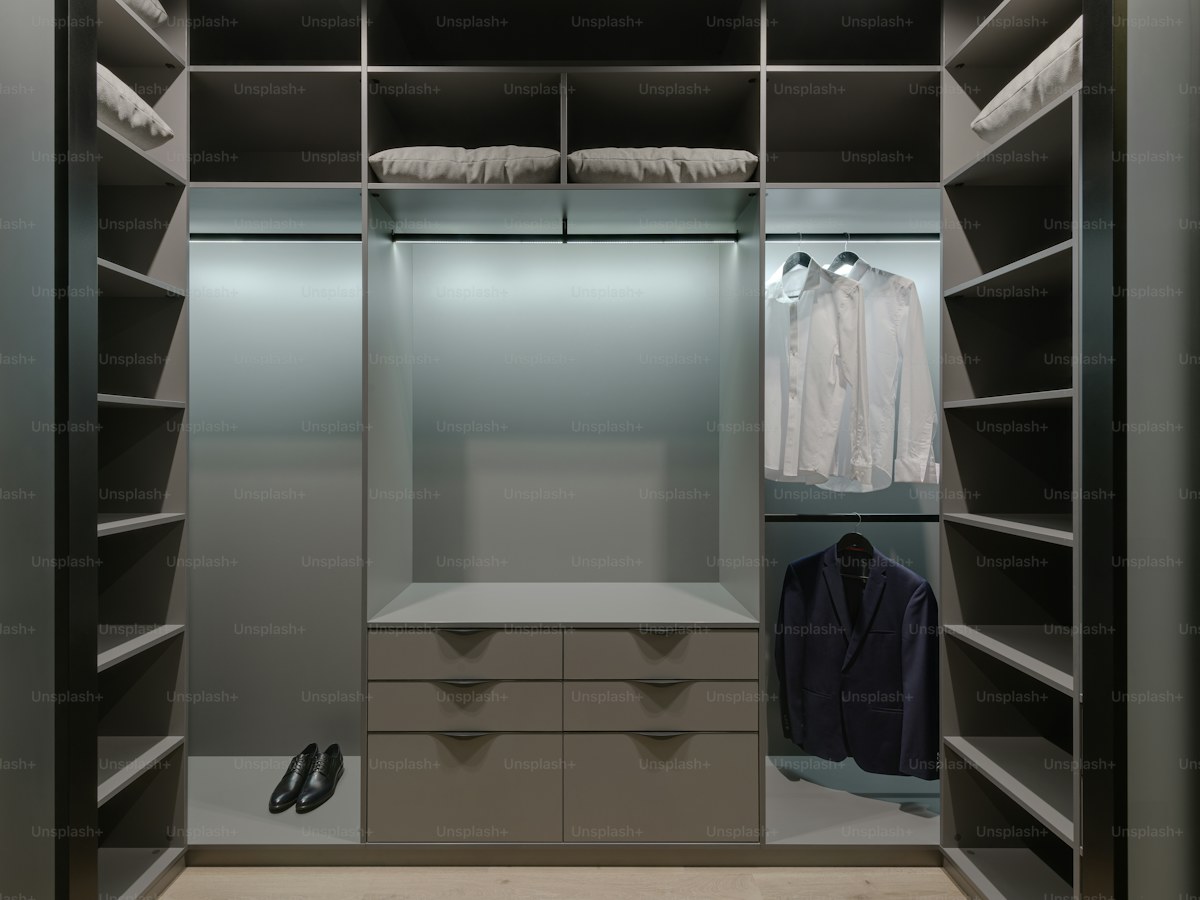 a walk in closet with a lot of shelves