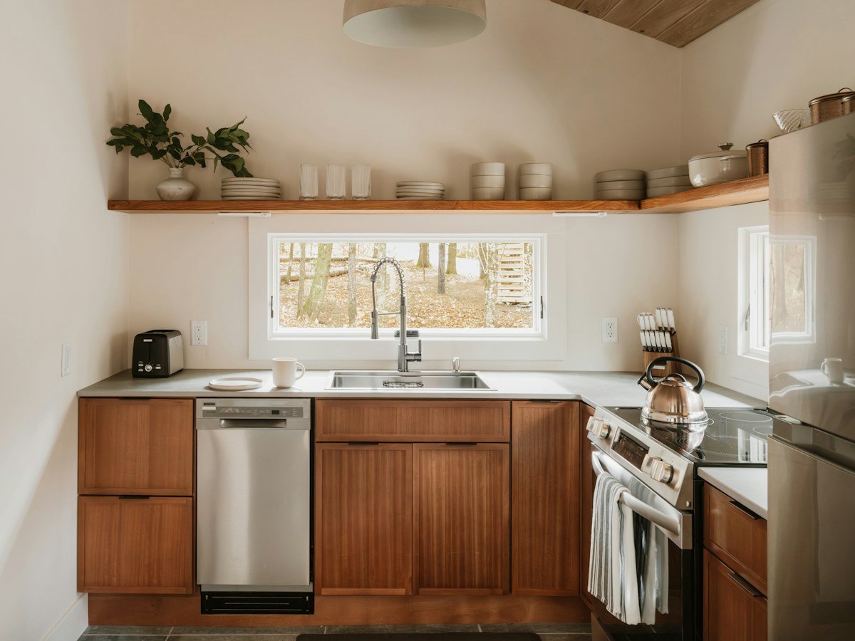 Modern kitchen with wooden cabinets and stainless steel appliances